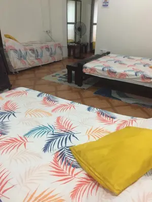 a room with two beds and a yellow blanket at La Coccinella in Manila