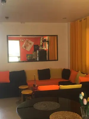 a living room with a couch and a table at La Coccinella in Manila
