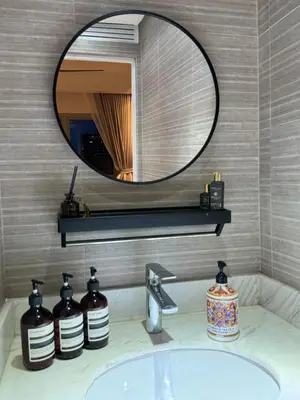 a bathroom sink with a large mirror above it at Modern 1BR Executive Suite l Best City View of BGC l The Residences BCCT in Manila