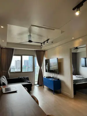 a living room with a couch and a bed and a mirror at Modern 1BR Executive Suite l Best City View of BGC l The Residences BCCT in Manila