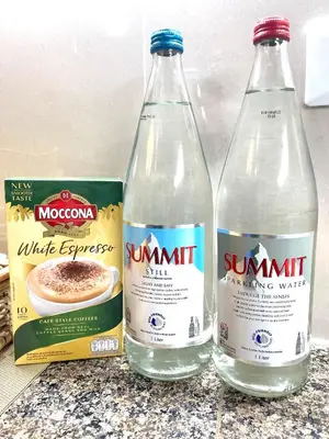 three bottles of water sitting on top of a counter at Cozy Place @ Venice Luxury Residences in Manila