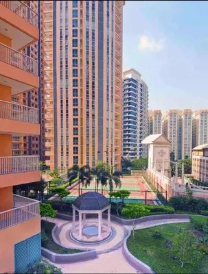 a park with a gazebo in front of tall buildings at Cozy Place @ Venice Luxury Residences in Manila