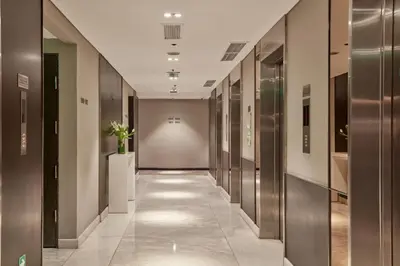 a hallway of a building with metal doors and a hallway sidx sidx sidx at F1 Hotel Manila in Manila