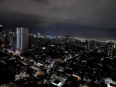 a view of a city at night with lights at Penthouse Lvl Luxury Cndo Nr MOA in Manila
