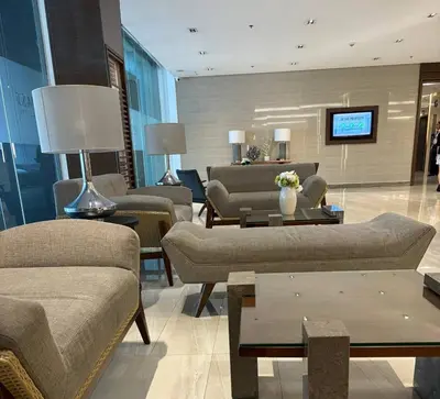 a lobby with couches and tables in a building at Penthouse Lvl Luxury Cndo Nr MOA in Manila