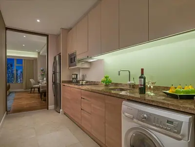 a kitchen with a washer and dryer in it at Ascott Bonifacio Global City Manila in Manila