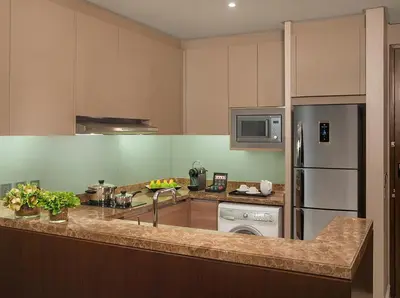 a kitchen with a refrigerator and a dishwasher at Ascott Bonifacio Global City Manila in Manila