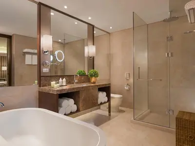 a bathroom with a tub and a shower and a toilet at Ascott Bonifacio Global City Manila in Manila