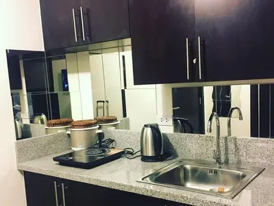 a kitchen with a sink and a counter top at Kasara Resort Condotel by Vhi in Manila