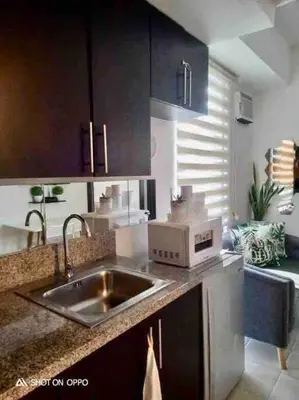 a kitchen with a sink and a microwave at Kasara Resort Condotel by Vhi in Manila