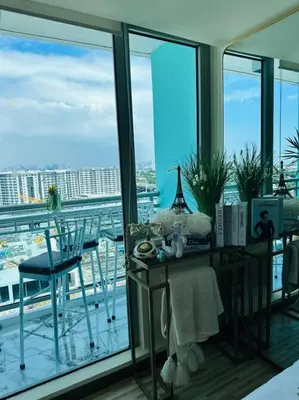 a room with a balcony with a table and chairs at Azure Urban Resort - St Tropez Tower Staycation Unit with a European Touch in Manila
