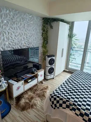 a bedroom with a bed and a large window at Azure Urban Resort - St Tropez Tower Staycation Unit with a European Touch in Manila