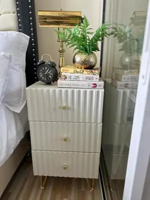 a nightstand with books and a plant on top of it at Azure Urban Resort - St Tropez Tower Staycation Unit with a European Touch in Manila