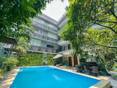 a swimming pool in front of a building at 88 Courtyard Hotel in Manila