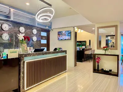 a store with a counter with clocks on the wall at 88 Courtyard Hotel in Manila