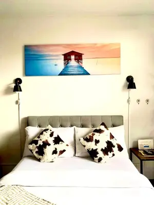 a bedroom with a bed with a picture of a lighthouse at Cozy and nature inspired studio rooms Mandaluyong Edsa at F Residences under new management in Manila