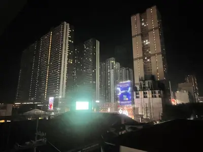 a city lit up at night with tall buildings at Cozy and nature inspired studio rooms Mandaluyong Edsa at F Residences under new management in Manila