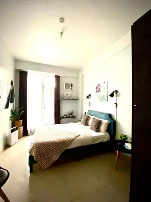 a bedroom with a large bed and a window at Cozy and nature inspired studio rooms Mandaluyong Edsa at F Residences under new management in Manila