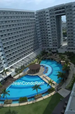an aerial view of a large building with a large swimming pool at Magayon Staycation Shell Residences Mall of Asia in Manila