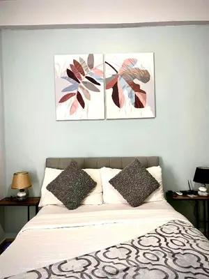 a bedroom with a bed with three pictures on the wall at Buenbyahe Rooms Studio Type Mandaluyong Edsa Shaw MRT Studio at F Residences Under new management in Manila