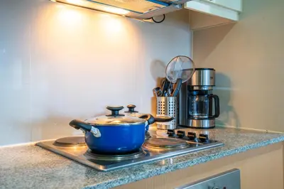a blue pot sitting on top of a stove in a kitchen at 2BR 2TB Uptown Parksuites BGC Balcony,fast WiFi,Washer in Manila