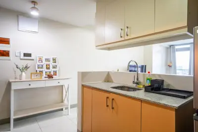 a kitchen with a sink and a counter top at 2BR 2TB Uptown Parksuites BGC Balcony,fast WiFi,Washer in Manila