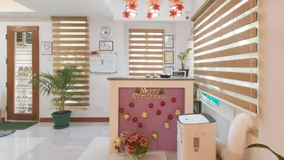 a kitchen with a christmas sign on the wall at Catlea Inn in Manila