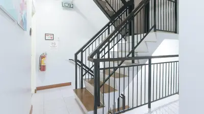 a staircase in a house with black railings at Catlea Inn in Manila