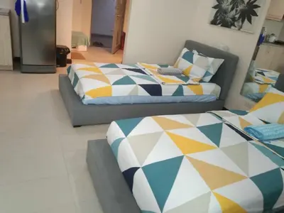 a bedroom with two beds and a couch at Twin Beds Studio Room with City View in Manila