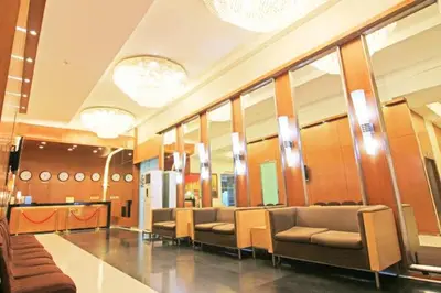 a waiting room with couches and mirrors in a building at Twin Beds Studio Room with City View in Manila