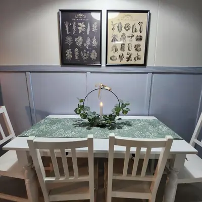 a dining room table with a candle on top at My Humble Abode at Shore 3 in Manila