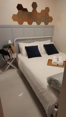 a bedroom with a large white bed with two pillows at My Humble Abode at Shore 3 in Manila