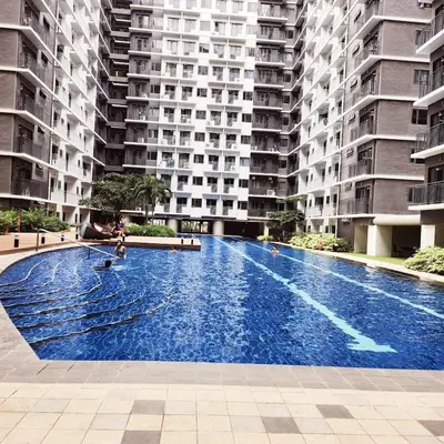 a large swimming pool in front of a building at My Humble Abode at Shore 3 in Manila
