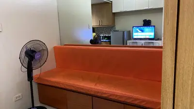 a room with a counter with a fan and a television at Shell Residences C19 Shortwalk Sm Mall Of Asia Airport in Manila