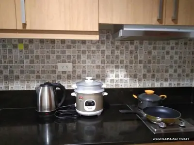 a toaster sitting on a kitchen counter next to a stove at Shell Residences C19 Shortwalk Sm Mall Of Asia Airport in Manila