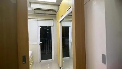 a hallway with two doors in a room at Shell Residences C19 Shortwalk Sm Mall Of Asia Airport in Manila