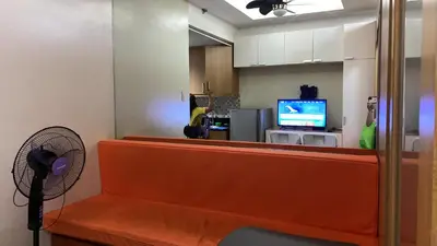 a waiting room with a cash register and a television at Shell Residences C19 Shortwalk Sm Mall Of Asia Airport in Manila