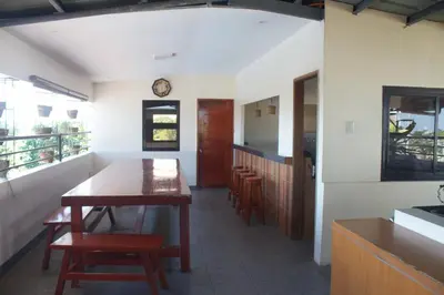 a kitchen with a table and chairs in a room at MaClare Resort in Imus