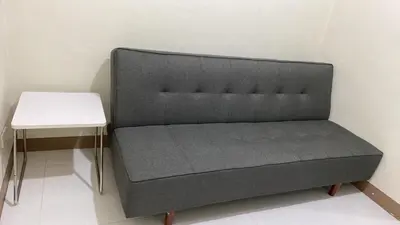 a bed sitting next to a white table at CHATEAU ELYSEE A16 Near Resto And Sm Mall/Airport in Manila