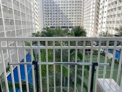 a balcony with a view of some buildings at SHORE RESIDENCE D17 shortwalk Mall of asia near airport in Manila