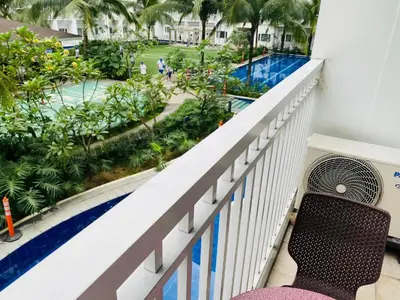 a balcony with a bench looking out at a pool at SHORE RESIDENCE D17 shortwalk Mall of asia near airport in Manila