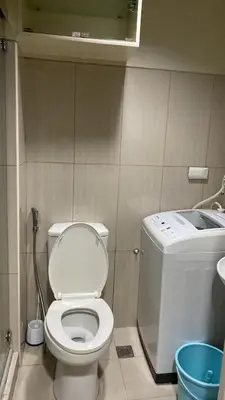 a bathroom with a toilet and a sink at Shell Residences C21 Shortwalk Sm Mall Of Asia Airport in Manila