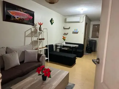 a living room with a couch and a table at B-G Sorento Oasis 2BR in Manila
