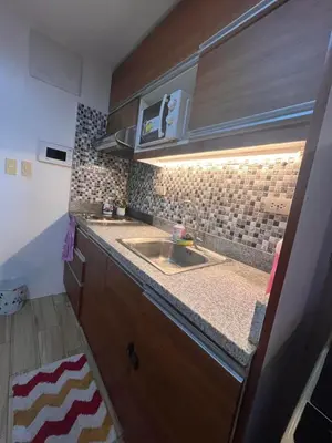 a kitchen with a sink and a counter top at JFam Suites, C3-11D Studio, Up To 4 Pax in Biñan