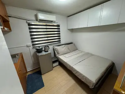 a small bedroom with a bed and a window at Condo in Pasig - One Oasis Staycation in Manila