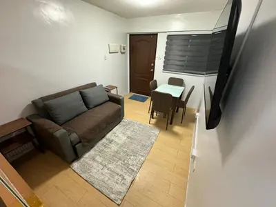 a living room with a couch and a table at Condo in Pasig - One Oasis Staycation in Manila