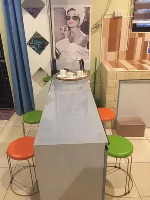a kitchen with a counter with four stools at Arcobaleno in Manila
