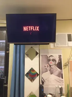 a netflix sign hanging on a wall at Arcobaleno in Manila