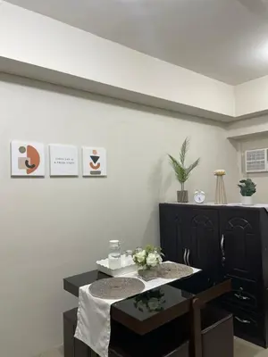 a dining room with a table and a tableablish at Makati Cozy Studio Apartment in Manila