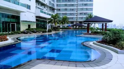 a swimming pool in the middle of a building at Makati Cozy Studio Apartment in Manila